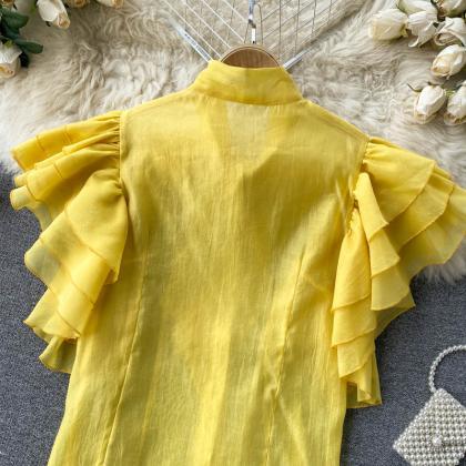 Small Design With Many Layers Of Ruffled Sleeves..